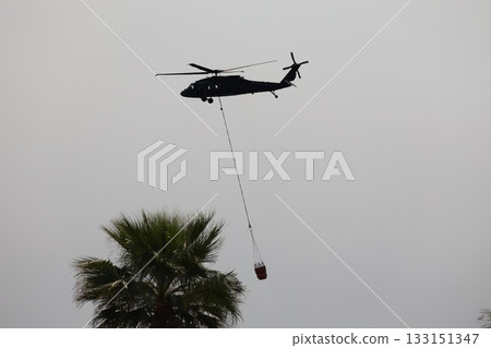 Bucket carrying helicopter. High quality photo 133151347