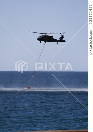 Bucket carrying helicopter.a helicopter scoops up water from the sea. High quality photo Bucket carrying helicopter.a helicopter scoops up water from the sea. High quality photo 133151432