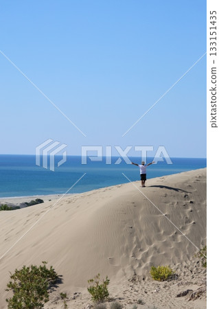 Beach dunes mountains natural beauty. boy alone in the desert. High quality 4k footage Beach dunes mountains natural beauty. boy alone in the desert. High quality 4k footage 133151435