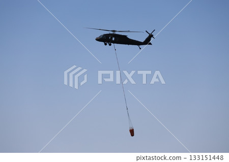Bucket carrying helicopter. High quality photo Bucket carrying helicopter. High quality photo 133151448