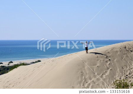 Beach dunes mountains natural beauty. boy alone in the desert. High quality 4k footage Beach dunes mountains natural beauty. boy alone in the desert. High quality 4k footage 133151616