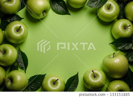 Fresh green apples are neatly arranged on a bright green surface, surrounded by green leaves. The scene evokes a sense of freshness and vitality, ideal for springtime Generative AI 133151885