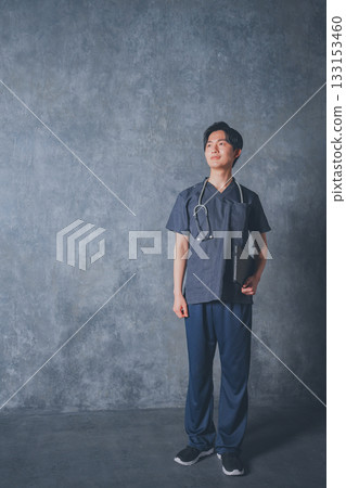 A young male doctor wearing a scrub A young male doctor wearing a scrub 133153460