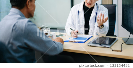 Doctor discusses brain scan results with patient using screen and clipboard. health care, neurology, diagnosis Doctor discusses brain scan results with patient using screen and clipboard. health care, neurology, diagnosis 133154431