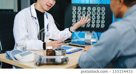 Doctor discusses brain scan results with patient using screen and clipboard. health care, neurology, diagnosis Doctor discusses brain scan results with patient using screen and clipboard. health care, neurology, diagnosis 133154433