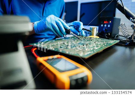 Electronics technician, electronic engineering electronic repair, electronics measuring and testing, repair and maintenance concepts. Electronics technician, electronic engineering electronic repair, electronics measuring and testing, repair and maintenance concepts. 133154574