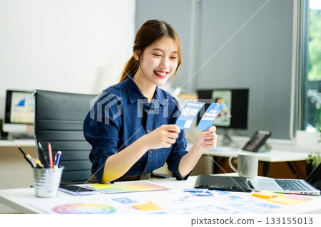 designer holds wireframe cards while planning UX/UI in a creative office, showcasing innovation, technology 133155013