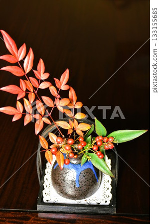 A small flower arrangement of nandina with red berries A small flower arrangement of nandina with red berries 133155685