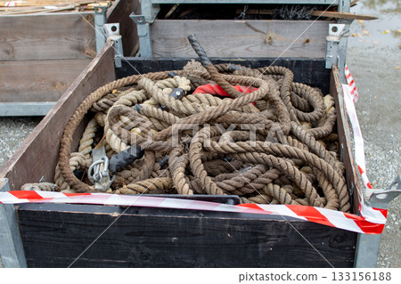 Old ropes stored in a wooden box at a construction site during autumn season Old ropes stored in a wooden box at a construction site during autumn season 133156188