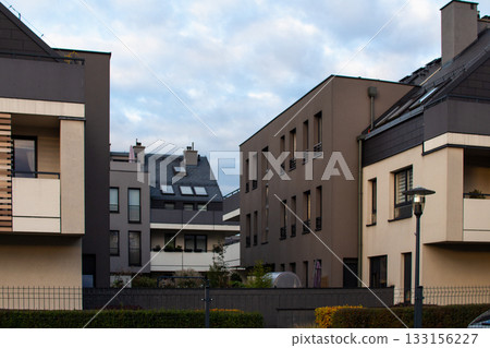 Modern apartment buildings in a quiet neighborhood during late afternoon 133156227