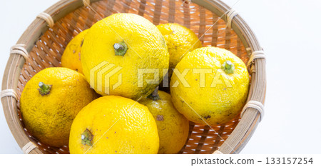 Harvested yuzu fruit in a monkey's Harvested yuzu fruit in a monkey's 133157254