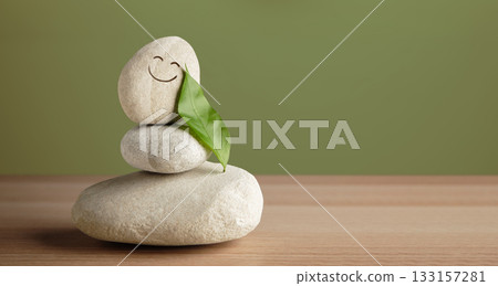 Smiling stone with leaf shows harmony of life, happiness, nature connection Smiling stone with leaf shows harmony of life, happiness, nature connection 133157281