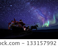 Santa flying through the night sky 133157992