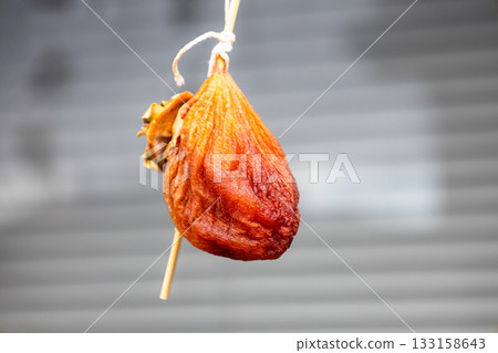 Delicious and nostalgic dried persimmons often seen drying on eaves in rural areas Delicious and nostalgic dried persimmons often seen drying on eaves in rural areas 133158643