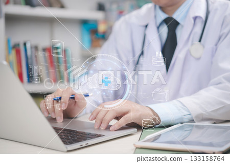 Doctor working on laptop with virtual cloud icons and healthcare data, cloud computing in the future of medical information management.digital transformation, health insurance, and online records. 133158764