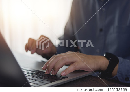 Hands typing on laptop keyboard, online collaboration, and technology, digital communication, and efficient workflow in a modern office environment. 133158769