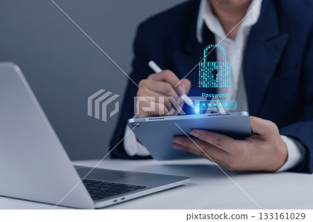 Business data security concept. A person entering a password on a tablet. Protecting online information, confidential data, and smart access. Data breach prevention and secure system. 133161029