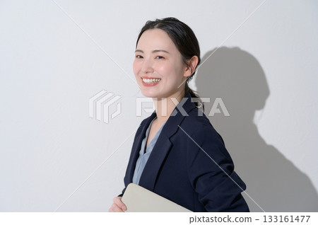 Japanese woman holding a laptop on a white background 133161477