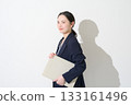 Japanese woman holding a laptop on a white background 133161496