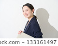 Japanese woman holding a laptop on a white background 133161497