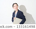 Japanese woman holding a laptop on a white background 133161498