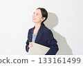 Japanese woman holding a laptop on a white background 133161499