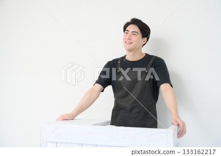 Japanese man standing at the reception desk 133162217