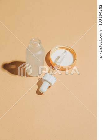 Cosmetic liquid bottle with pipette dropper Cosmetic liquid bottle with pipette dropper 133164282