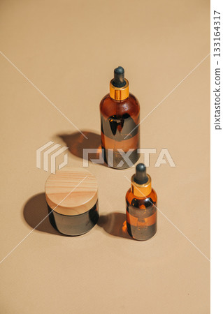 Dark glass cosmetic cream jar beige background Dark glass cosmetic cream jar beige background 133164317