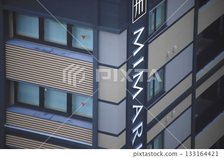 Windows on the building wall and signboard on the side Windows on the building wall and signboard on the side 133164421