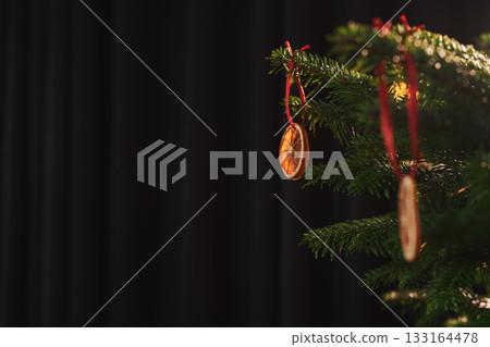 Closeup small christmas tree with natural decorations indoor Closeup small christmas tree with natural decorations indoor 133164478