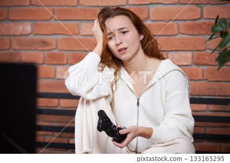 A gamer plays a game A gamer plays a game 133165295