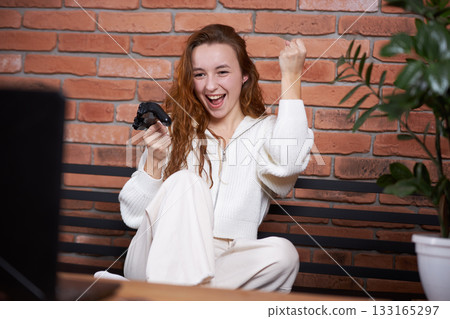 A gamer plays a game 133165297