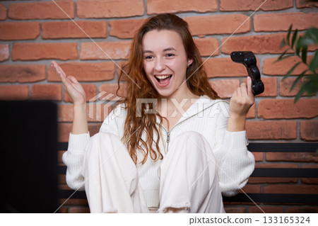 A gamer plays a game 133165324