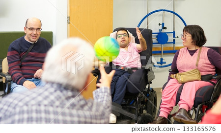 Group of adults with physical disabilities playing ball Group of adults with physical disabilities playing ball 133165576
