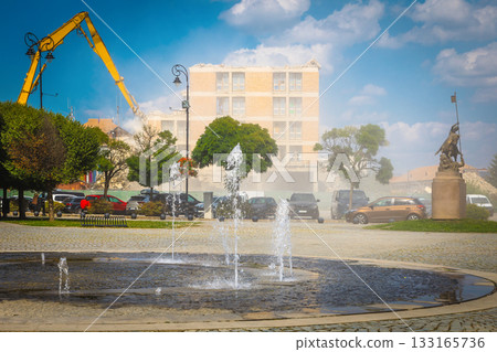 Demolition of the old skyscraper using building hydraulic shears 133165736