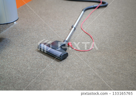 vacuum cleaner on floor 133165765