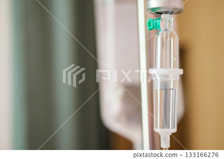 Close up medical intravenous IV drip in hospital background 133166276