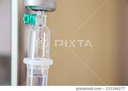 Close up medical intravenous IV drip in hospital background Close up medical intravenous IV drip in hospital background 133166277