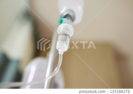 Close up medical intravenous IV drip in hospital background 133166278