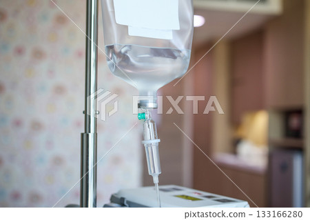 Close up medical intravenous IV drip in hospital background Close up medical intravenous IV drip in hospital background 133166280