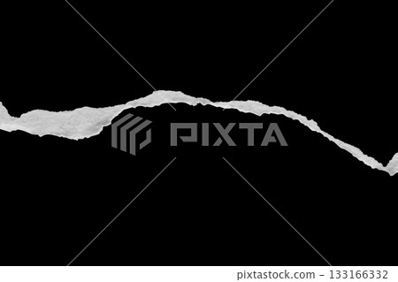 Ripped torn paper edges isolated on black background Ripped torn paper edges isolated on black background 133166332