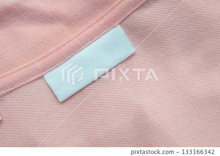 White blank laundry care clothes label on shirt fabric background 133166342