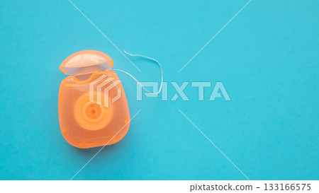 dental floss in case on blue background 133166575