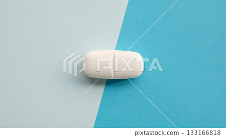 White medicine pill tablet on blue and white background White medicine pill tablet on blue and white background 133166818
