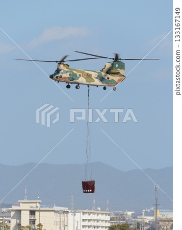 Japan Air Self-Defense Force CH-47 and Big Dipper Bucket flying over the city 133167149