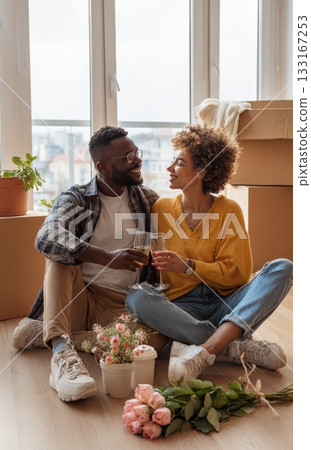 Happy couple toasting with wine in new apartment Happy couple toasting with wine in new apartment 133167253