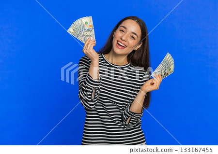 Rich happy woman winner waving money dollar cash like a fan, big income wealth success business Rich happy woman winner waving money dollar cash like a fan, big income wealth success business 133167455