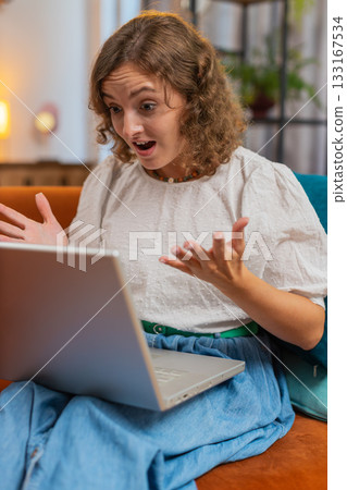 Angry stressed young Caucasian woman talking laptop using computer webcam video call on sofa at home Angry stressed young Caucasian woman talking laptop using computer webcam video call on sofa at home 133167534