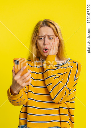 Upset sad woman use smartphone play game loses loss fail unlucky news bad lottery results crisis Upset sad woman use smartphone play game loses loss fail unlucky news bad lottery results crisis 133167592